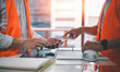 © cherdchai - engineers or foreman workers discussion project using smartphone and wearing safety shirt on work site