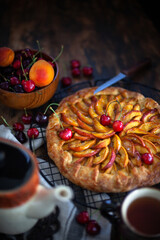 Wall Mural - Rustic open peach pie (galette) with peach and cherry