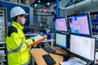© reewungjunerr - Inside the large Industry Factory Female Computer Engineer Works on Personal Computer She coding program for control machine,Thailand people work on fours monitors,Programmer working with serious