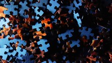 Background Of Colored Puzzle Pieces That Slowly Rotating Clockwise - Top View. Texture Of Incomplete Red And Blue Jigsaw Puzzle With Low Key Light - Right Rotation