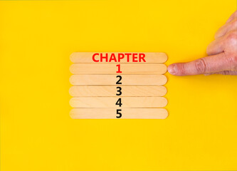 Wall Mural - Time to chapter 1 symbol. Concept word Chapter 1 2 3 4 5 on wooden sticks. Businessman hand. Beautiful yellow table yellow background. Business planning and time to chapter 1 concept. Copy space.