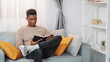© golubovy - Book leisure. Domestic reading. Home relaxing. Happy man enjoying literature weekend rest on comfortable sofa at cozy living room free space.