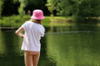 © Oleg - Girl fishing on a lake beach. Summer leisure near the water