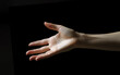 © Margo_Alexa - hand on a black background .feelings shown by hands. copyspace. Generative AI