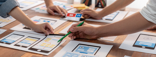 Aufkleber - Panorama shot of front-end developer team brainstorming UI and UX designs for mobile app on paper wireframe interface. User interface development team planning for user-friendly UI design. Scrutinize