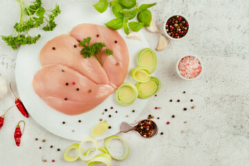 Wall Mural - Raw fresh chicken fillet on a gray background with fresh herbs.Raw chicken meat.Copy space.Food for retail.Ogranic food,healthy eating.Food concept.Top view.Chicken breast Fillets.Close up.