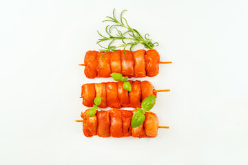 Wall Mural - Chicken Skewers meat.Fresh raw marinated chicken leg meat skewers without skin on a white background.Marinated Fresh.Closeup of chicken meat.Procurement for designers.