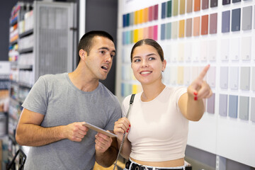 Wall Mural - In hardware store, husband and wife are arguing about which ceramic tile to choose for the kitchen or bathroom.