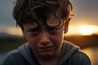 a closeup photo of a young boy child crying outside at a sunset, wet eyes and hair. Generative AI