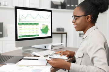 Canvas Print - Professional accountant working at wooden desk in office