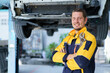 © DG PhotoStock - Professional caucasian white automobile technician holding a wrench and making crossed arms and looking at camera.