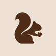silhouette of a squirrel holding an acorn logo
