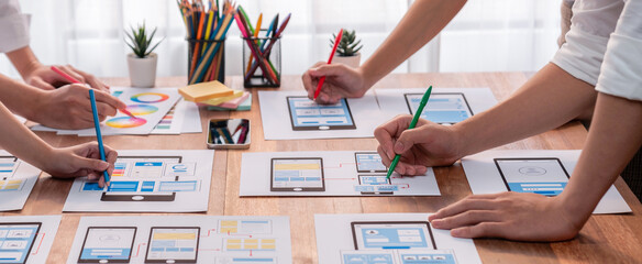 Aufkleber - Panorama shot of front-end developer team brainstorming UI and UX designs for mobile app on paper wireframe interface. User interface development team planning for user-friendly UI design. Scrutinize