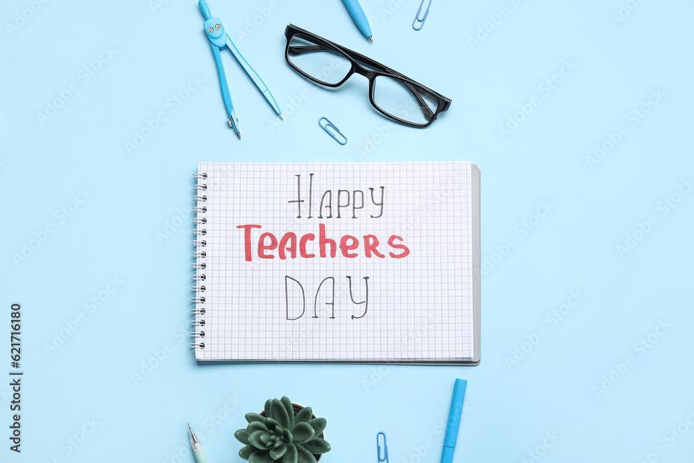 Notebook with text HAPPY TEACHERS DAY, eyeglasses and stationery on blue background