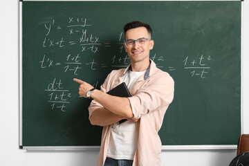 Sticker - Male Math teacher conducting lesson near chalkboard in classroom