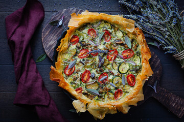 Wall Mural - Delicious vegetarian summer quiche with zucchini, tomato, mushrooms, sage and lavender with phyllo pastry