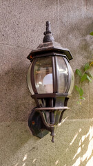 decorative lamp in black on the wall of the house