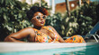 © Robert Kneschke - Body-positive woman lounging by pool in trendy outfit