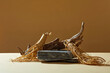 © Tuan  Nguyen  - Abstract background with minimalist style for product display on stone with ginseng roots and dry twig on brown background. Front view, ginseng root with natural origin has many health benefits