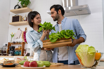 Young couple enjoy while cooking meal in kitchen at home