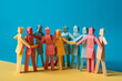 © ink drop - A group of paper people coming together as a team to support each other