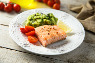 Canvas Print - Healthy baked salmon fillet with mashed avocado