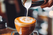 Professional barista pouring milk and making latte art. Coffee shop interior and closeup of making cappuccino.