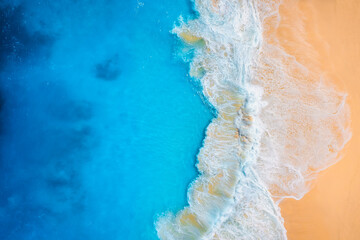 Wall Mural - coast as a background from top view. waves and beach. aerial landscape. azure water background from 