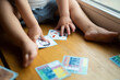 a small child plays with developing cards from a board game
