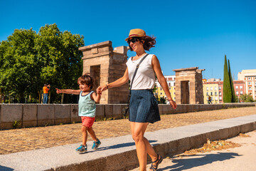 Wall Mural - Temple of Debod in the city of Madrid of Egypt, mother and son having fun in the ancient Egyptian temple