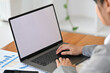 © saltdium - Behind shoulder view image of Young business woman with suit outfit working with laptop, Empty screen of laptop.