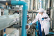 © FotoArtist - Female worker inspecting water bottle on production line in spring water factory