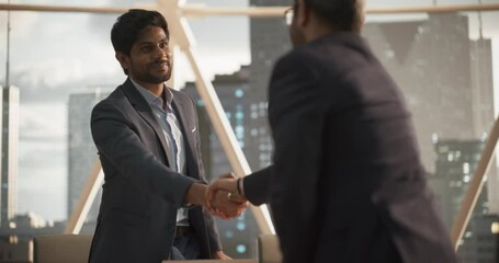 Aufkleber - Young Indian Businesspeople Closing a Business Deal at a Meeting Room in Corporate Modern Office. Two Men in Classic Suits Shake Hands and Celebrate Successful Partnership