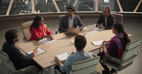 Poster - High Angle Footage of a Diverse Team of Professional South Asian Businesspeople Meeting in an Office Conference Room. Creative Team Sitting Behind a Table, Discussing Social Media Marketing Strategy