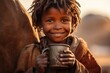 Drought, the problem of lack of water. A joyful child in Africa close-up drinks water from a mug