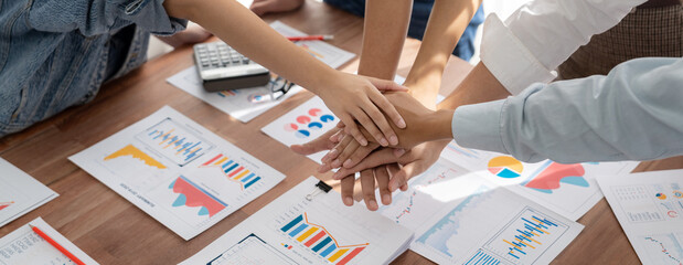Aufkleber - Analyst team putting hand together after successfully analyzed financial dashboard papers for business strategy and marketing. Teamwork and unity in office with stack hands. Panorama shot. Scrutinize