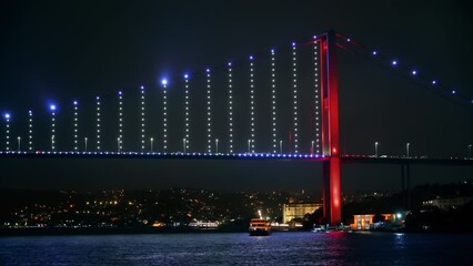 Wall Mural - View of Bosphorus Bridge at night in Istanbul, Turkey. View from a floating ship, illumination, moving on the bridge cars