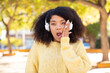 © kues1 - pretty afro black woman feeling extremely shocked and surprised. listening music with headphones