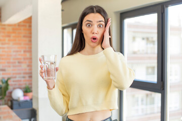 Wall Mural - pretty young model feeling extremely shocked and surprised. water glass concept