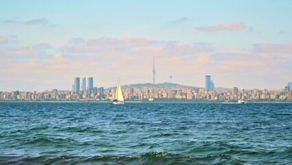 Canvas Print - Cityscape of Istanbul from another shore of the Bosphorus Strait, Turkey. Floating boats, a lot of buildings and Camlica Tower in the distance, fog in the air