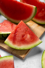 Wall Mural - Fresh red juicy watermelon slices on cutting board.