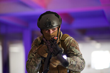 Wall Mural - A professional soldier undertakes a perilous mission in an abandoned building illuminated by neon blue and purple lights