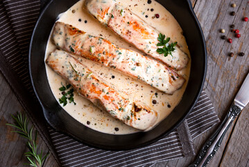 Wall Mural - Cooked salmon fish with cream sauce in frying pan