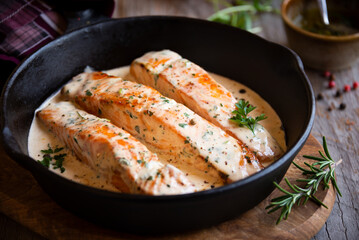 Wall Mural - Cooked salmon fish with cream sauce in frying pan