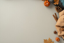 Experience The Cozy Bliss Of Autumn At Home With This Above View Photo Of Patchy Scarf, Pumpkin Candles, Maple Foliage, Chinese Anise With Cinnamon Set The Scene For Text Or Advert On Grey Background