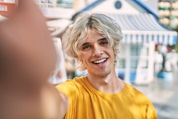 Canvas Print - Young blond man smiling confident making selfie by camera at street