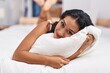Young beautiful hispanic woman hugging pillow lying on bed at bedroom