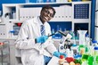 © Krakenimages.com - African american man scientist looking tomato using loupe at laboratory