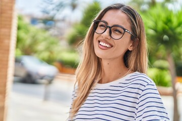 Sticker - Young blonde woman wearing glasses looking to the side at street