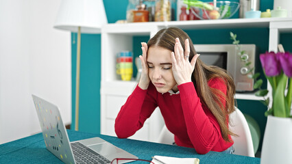 Canvas Print - Young hispanic woman using laptop stressed at dinning room